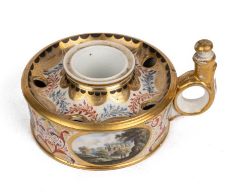 A Derby ink well C.1815, of cylindrical form, with a looping handle, decorated with country scenes on a scroll and foliated g