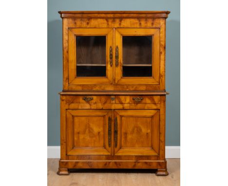 A 19th century French cherrywood buffet du corps The glazed upper section with two doors enclosing a shelf above two drawers 