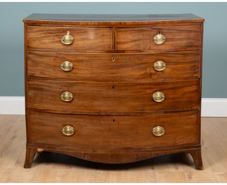 A Georgian mahogany bow-fronted chest of drawers The chest with a crossbanded top over two short and three long drawers, with