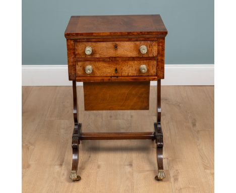 A Regency walnut work table With two drawers to the frieze, the first drawer opening to reveal a blue velvet inset writing sl