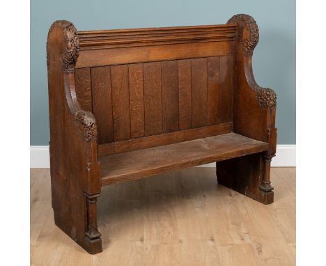A 19th century oak church pew The ends carved with foliate motifs.129cm wide x 50cm deep x 117cm highQty: 1In generally good 