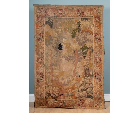 A 17th century-style verdure tapestry The central scene depicting a woodland view within a floral border. 146cm wide x 220cm 