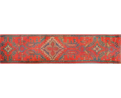 An early 20th century hand-woven woollen Oushak runner With red ground and foliate decoration, cut into two halves.297cm x 76