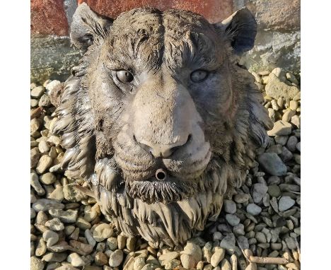 A reconstituted stone tiger mask fountainhead With copper pipe running through the mouth.30cm highQty: 1Some light weathering