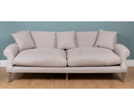 A large contemporary sofa by Loaf With scrolling arms and turned tapering front legs.248cm wide x approximately 109cm deep x 
