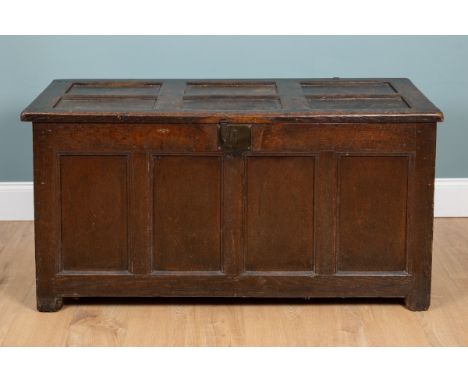 An early 18th century oak coffer Of pegged construction, with a quadruple-panelled front and original iron loop hinges, the t