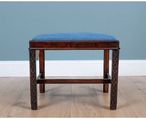 A Chippendale-style mahogany-framed dressing table stool The blue upholstered inset seat over a stool with blind fretwork dec