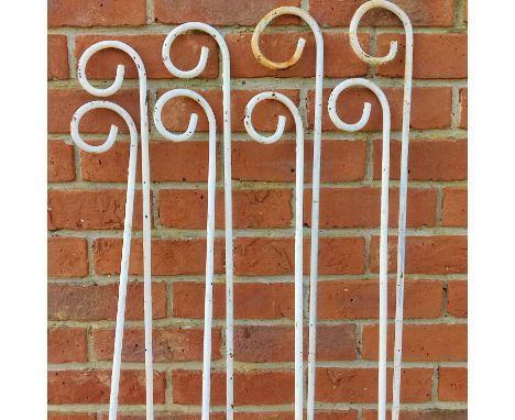 A set of eight white-painted iron plant supports With curling ends.Each 143cm highQty: 8Oxidisation throughout commensurate w