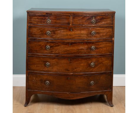 A George III mahogany bow-front chest of drawers With two short over four long graduated drawers with brass ring handles and 