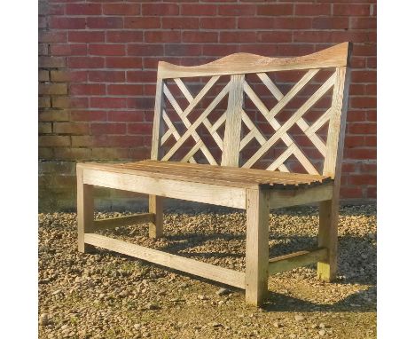 A teak garden bench by Charles Verey With shaped top rail.113cm x 93.5cmQty: 1Some losses to the plugs covering the screws, w