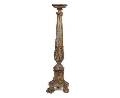 An antique Continental gold and silvered carved pine pricket candlestick With a tapering column, triform base, and paw feet.6