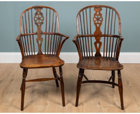 Two Windsor armchairs With elm seats. One with a crinoline stretcher.53cm x 104cm. 57cm x 100cm.Qty: 2The first with legs sna
