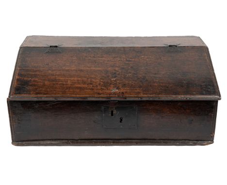 A 17th/18th century oak bible box or desk The fall-front opening to reveal three small drawers within, with an iron lock plat