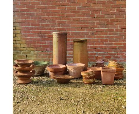 A collection of terracotta garden pots Together with pot dishes; pot stands; chimney pots; and a cast composite planter.Vario