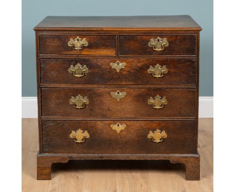 A George III oak chest of drawers With two short over three long graduated drawers with brass swan neck handles, raised on br