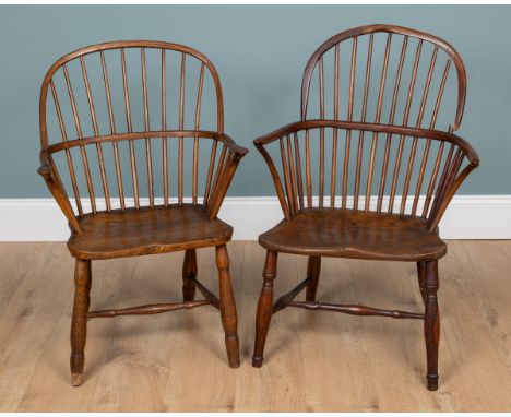 Two Windsor chairs With spindle-back, elm seats and H-frame stretchers. 62cm x 89cm & 58cm x 85cmQty: 2The first with notable