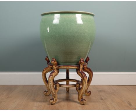 A large Chinese celadon ceramic planter and wooden stand The planter of bulbous form and with crackle decoration to the glaze