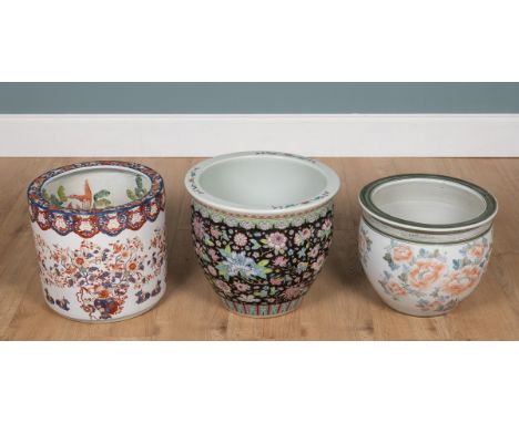 Three 20th century porcelain Japanese fish bowls The first with Imari decoration and fish painting within; the second with fl
