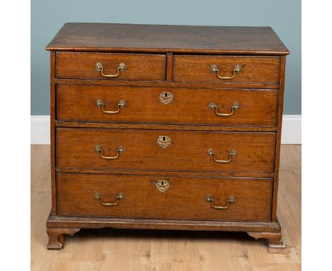 A Regency oak chest of drawers With four long graduated drawers with brass swan neck handles raised on ogee bracket feet. 92c