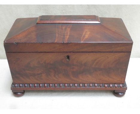 A Regency style 19th century mahogany veneered sarcophagus form tea caddy, with two lidded compartments and later mixing bowl