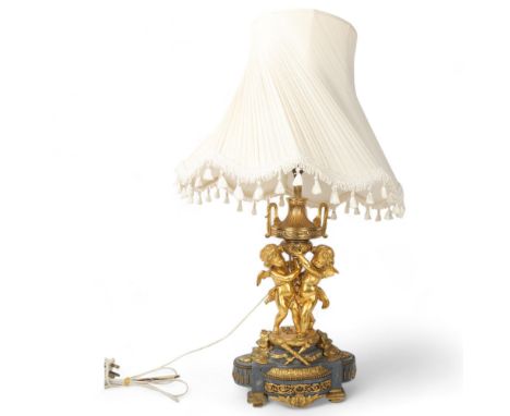 An ornate French gilt-bronze table lamp, supported by 2 cherubs, probably late 19th century, on ormolu mounted grey marble ba
