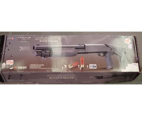 M56C multi shot spring powered airsoft shotgun with shell, working at lotting. P&amp;P Group 3 (£25+VAT for the first lot and