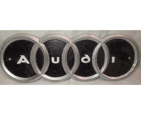 Cast iron Audi rings plaque, W: 25 cm. P&amp;P Group 1 (£14+VAT for the first lot and £1+VAT for subsequent lots) 