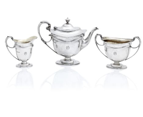 A three piece silver tea serviceby Martin Hall &amp; Co Ltd, Sheffield 1906/10 Comprising teapot, cream jug and sugar bowl, e