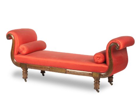 A George IV rosewood and brass inlaid chaise longueUpholstered in red silk with two bolster cushions, raised on turned feet w