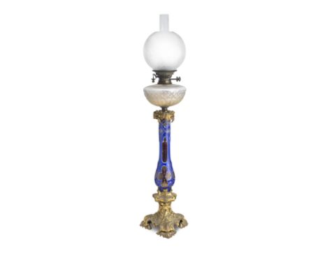 A Bohemian glass and gilt metal mounted oil lampLate 19th CenturyWith clear cut glass reservoir on ruby and blue overlaid col