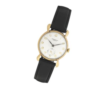 Universal: A 9k gold manual wind wristwatchBirmingham 1975The white dial with Arabic numerals and subsidiary seconds dial, th