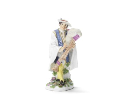 A Meissen figure of the Piedmontese piperCirca 1745Modelled by J.J. Kaendler, wearing a wide-brimmed hat, blue patterned doub