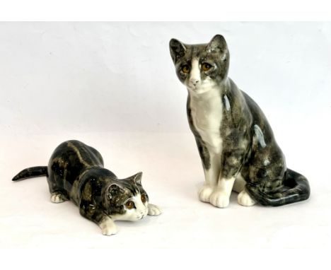 Two Mike Hinton for Winstanley pottery cats - with glass eyes, signed to base, the seated cat 23.6cm high.* Both are in very 