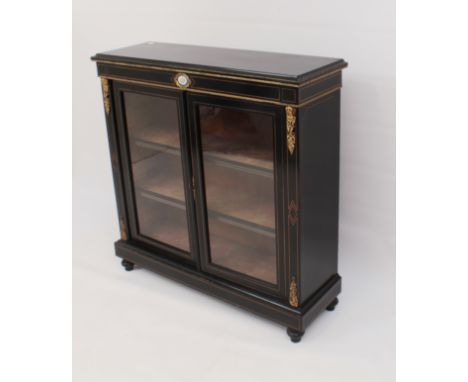 A mid-19th century English ebonised and gilt brass bookcase or vitrine in the Louis XVI taste - with boxwood geometric inlays