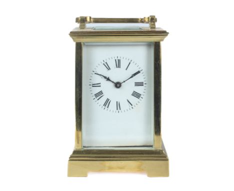 A brass single train carriage clock - mid-20th century, with white Roman enamel dial and key, 11.3cm high plus handle.