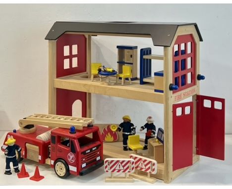 A large wooden toy Fire Station by Pin Toy - early 21st century, the two storey station with open sides and double doors to e