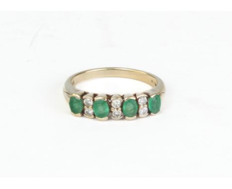 A 9ct yellow gold, emerald and diamond ten stone ring - Birmingham import hallmarks, with four oval cut emeralds divided by p