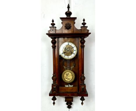 A Vienna style walnut eight day wall clock - c.1900, the raised architectural pediment and ogee base each with three turned f