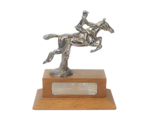 A silver plated and light oak horse eventing trophy - the plated figure of a jumping horse and rider on a light oak plinth wi