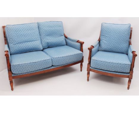 A Wesley Barrell two-seater showframe settee and matching armchair - beech framed, with angular backs, scroll arms on turned 