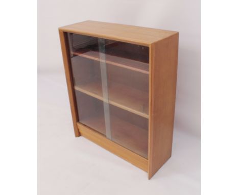 A 1960s light oak glazed bookcase - with a pair of sliding glass doors and two adjustable shelves. (LWH 68.5 x 25.5 x 84cm)