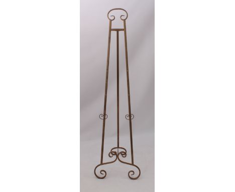 A gilt-metal floor-standing easel - with two scroll-form rests adjustable in three positions, on scrolled bases, 175 cm high,