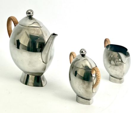 A Nick Munro pewter modernist three piece tea service - of flattened globular form, with ball finials, flared feet and rattan