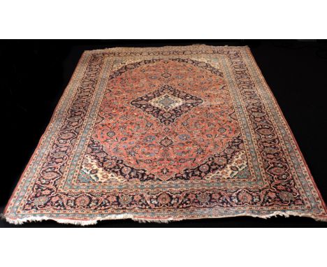 An Iranian Kashan hand-knotted wool rug - late 20th century, the central dark-blue and ivory lozenge pendant medallion on a p