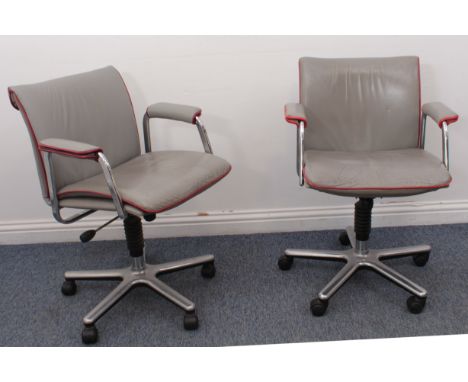A pair of vintage light-grey leather swivel desk-chairs - 1980s, piped in red, with chrome arms, height adjustable, the cast 