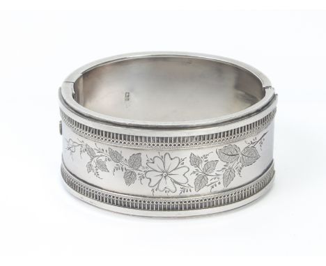 A Victorian silver cuff bangle - Thomas Hayes, Birmingham 1882, with chased floral and foliate decoration, the band 3.1cm wid