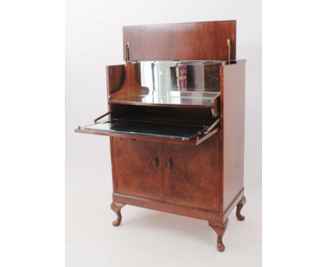 A mid-century burr walnut cocktail cabinet - 1950s, the centre hinged top and fall front opening on a cantilevered mechanism 