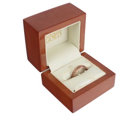 A 9ct rose gold ring by Clogau - the band with interlaced Celtic style design, size R, in the original box with outer card bo