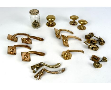A collection of brass architectural hardware - modern in the antique style, including door knobs and handles; window stays; l