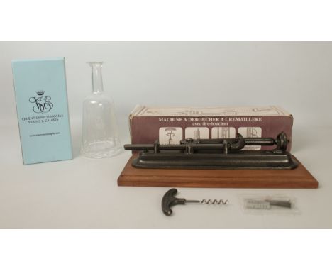 Two pieces: 1. a French Tire-Bouchon cast-iron wall-mounted corkscrew - unused, in the original box;  2. a boxed Orient Expre